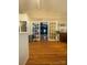 Open living room area with hardwood floors leading to a cozy space with a brick fireplace feature at 903 Woodside Dr, Kings Mountain, NC 28086