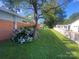 Well-maintained side yard with a blooming hydrangea bush and a view of the neighboring houses at 903 Woodside Dr, Kings Mountain, NC 28086