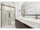 Modern bathroom features a double sink vanity, marble countertops, and sleek glass shower with gold fixtures at 9930 Sardis Oaks Rd, Charlotte, NC 28270