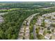 An aerial view of a residential neighborhood with lush green trees in a suburban setting at 10349 Alvarado Way, Charlotte, NC 28277