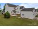 Well-maintained backyard with a patio, lush lawn, and a detached garage with a door at 10349 Alvarado Way, Charlotte, NC 28277