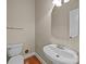 Half bathroom featuring modern sink, toilet, and wooden flooring at 10349 Alvarado Way, Charlotte, NC 28277