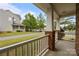 View from the porch of a two-story home with brick columns and white railings in a suburban neighborhood at 10349 Alvarado Way, Charlotte, NC 28277