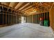 Spacious garage with unfinished ceiling, concrete floor, garage door, and blacked out walls at 10349 Alvarado Way, Charlotte, NC 28277