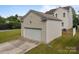 A well-maintained detached garage with a functional overhead door and neutral color at 10349 Alvarado Way, Charlotte, NC 28277
