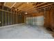 Spacious garage with unfinished ceiling, concrete floor, garage door, and blacked out walls at 10349 Alvarado Way, Charlotte, NC 28277