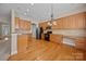 Spacious kitchen features wood cabinets, stainless steel appliances, and hardwood flooring at 10349 Alvarado Way, Charlotte, NC 28277