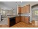 Charming kitchen with wood cabinets, modern appliances, and hardwood floors at 10349 Alvarado Way, Charlotte, NC 28277