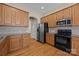 Kitchen boasts wood cabinets, stainless steel refrigerator, and modern appliances at 10349 Alvarado Way, Charlotte, NC 28277