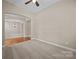 Large living room with neutral carpeting leading to a dining room at 10349 Alvarado Way, Charlotte, NC 28277