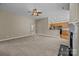 Spacious living room with fireplace, neutral carpeting and view of the kitchen at 10349 Alvarado Way, Charlotte, NC 28277