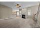 Spacious living room with a fireplace, ceiling fan, and open access to the kitchen for entertaining at 10349 Alvarado Way, Charlotte, NC 28277