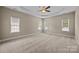Spacious main bedroom featuring neutral decor, ceiling fan, and ample natural light at 10349 Alvarado Way, Charlotte, NC 28277