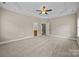 Bright and airy main bedroom features an en-suite bathroom and neutral carpeting at 10349 Alvarado Way, Charlotte, NC 28277
