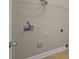 A look at the hook ups for a washer and dryer, with tile floors and wire shelving in a small room at 10349 Alvarado Way, Charlotte, NC 28277