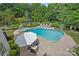 Aerial view of a backyard featuring a swimming pool, hot tub, and outdoor living space surrounded by lush landscaping at 109 Walking Horse Trl, Davidson, NC 28036