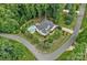 A lush aerial view of a home with a pool, landscaping, mature trees, and a large backyard space at 109 Walking Horse Trl, Davidson, NC 28036