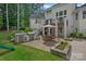 Spacious backyard with outdoor kitchen, seating area, covered deck, and landscaped gardens, ideal for entertaining at 109 Walking Horse Trl, Davidson, NC 28036