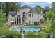Expansive backyard with a large pool, spa, outdoor kitchen, and seating area perfect for entertaining and relaxation at 109 Walking Horse Trl, Davidson, NC 28036