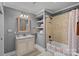 Bathroom features tiled shower/tub combination, neutral color scheme, and granite-topped vanity with sink at 109 Walking Horse Trl, Davidson, NC 28036