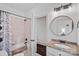Spacious bathroom with shower/tub, granite-topped vanity and sink with bronze fixtures and dark floors at 109 Walking Horse Trl, Davidson, NC 28036