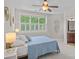 Comfortable bedroom with natural light from a big window with white shutters, adjacent to a full bathroom at 109 Walking Horse Trl, Davidson, NC 28036
