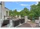 Outdoor deck features comfortable seating with picturesque views of the wooded yard and neighboring play structure at 109 Walking Horse Trl, Davidson, NC 28036