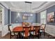 Formal dining room featuring elegant lighting, wainscoting, and ample seating for hosting memorable gatherings at 109 Walking Horse Trl, Davidson, NC 28036