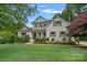 Traditional style house with manicured lawn, mature trees, and a welcoming front porch at 109 Walking Horse Trl, Davidson, NC 28036