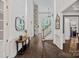 Elegant foyer boasts soaring ceilings, a stone fireplace, and hardwood floors, creating a grand and inviting entrance at 109 Walking Horse Trl, Davidson, NC 28036