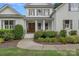 Beautiful home featuring a covered entrance, complemented by meticulously landscaped surroundings and a curving walkway at 109 Walking Horse Trl, Davidson, NC 28036