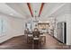 Open kitchen and dining area features hardwood floors, beams and exposed stone, and stainless appliances at 109 Walking Horse Trl, Davidson, NC 28036