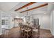 Kitchen and dining area featuring a large wood table, stainless steel appliances, and exposed beam ceiling at 109 Walking Horse Trl, Davidson, NC 28036