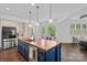 Stunning kitchen island with wood countertop and modern stainless steel appliances at 109 Walking Horse Trl, Davidson, NC 28036