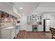 Stylish kitchen with stone accent wall, stainless steel appliances, and granite countertops, blending rustic and modern design at 109 Walking Horse Trl, Davidson, NC 28036