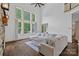 Bright living room features high ceilings, oversized windows, and a comfortable sectional sofa at 109 Walking Horse Trl, Davidson, NC 28036