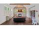 Comfortable living room featuring a stone fireplace, wood beam, and natural light from the windows at 109 Walking Horse Trl, Davidson, NC 28036