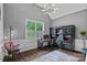 Well-lit home office with built-in shelving, wainscoting, and a large window overlooking lush greenery at 109 Walking Horse Trl, Davidson, NC 28036