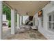 Covered patio with stone floor, plenty of seating, ceiling fan, and an outdoor TV at 109 Walking Horse Trl, Davidson, NC 28036