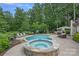 Backyard oasis featuring a swimming pool, hot tub, lounge chairs, and outdoor kitchen area at 109 Walking Horse Trl, Davidson, NC 28036