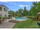 Beautiful backyard pool with lush landscaping, patio seating, and a swing set for outdoor enjoyment at 109 Walking Horse Trl, Davidson, NC 28036