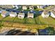 Backyard view of the home which is bordered by a black metal fence near a pond at 112 Aspire Cir, Wingate, NC 28174