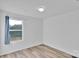 Bedroom with wood-look floors, bright window, and neutral paint, creating a serene space at 112 Aspire Cir, Wingate, NC 28174