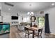 Inviting dining area with a wooden table, seating for four, and an open view to the living room at 112 Aspire Cir, Wingate, NC 28174