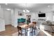 Open-concept dining room with wood table, chandelier, fish tank, and access to the living room at 112 Aspire Cir, Wingate, NC 28174