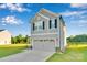Well-maintained gray home with a two-car garage, manicured lawn, and classic architectural details at 112 Aspire Cir, Wingate, NC 28174