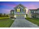 Beautiful two-story home featuring a gray exterior, a two-car garage, and a well-manicured lawn at 112 Aspire Cir, Wingate, NC 28174