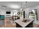 Stylish kitchen island featuring granite countertops, stainless steel sink, and an open layout to the living spaces at 112 Aspire Cir, Wingate, NC 28174