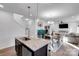 Modern kitchen island with granite countertops, stainless steel appliances, and open access to the dining area at 112 Aspire Cir, Wingate, NC 28174