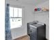 Well-lit laundry room with modern appliances and shelving for storage solutions at 112 Aspire Cir, Wingate, NC 28174
